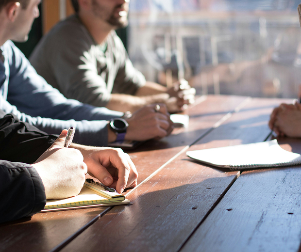 Close up of people having a meeting at a table